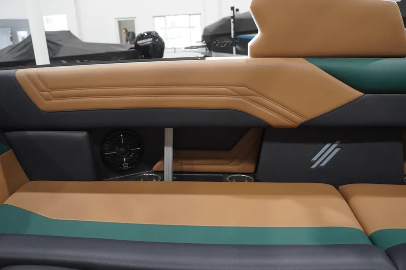Slide: The Image of 2025 ATX Surf Boats 24 Type-S interior with tan and green upholstery, featuring sleek design elements. - 77