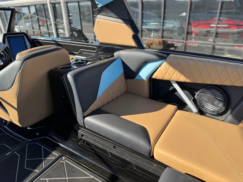 Slide: The Image of 2023 Tigé Z3 boat interior with tan and blue seating, modern design. - 10