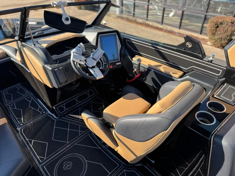 Slide: The Image of 2023 Tigé Z3 boat interior with modern dashboard, touchscreen, and tan-black seating. - 13