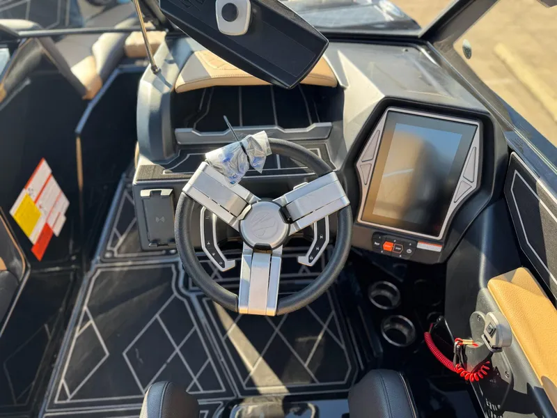Slide: The Image of 2023 Tigé Z3 boat interior with modern steering wheel and touchscreen display. - 14