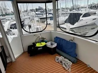 Slide: The Image of 1995 Carver 440 Aft Cabin Motor Yacht interior with marina view, featuring nautical equipment. - 11