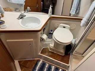 Slide: The Image of 1995 Carver 440 Aft Cabin Motor Yacht bathroom with sink, toilet, and shower. - 15