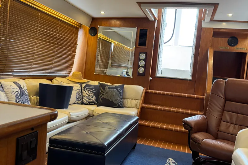 Slide: The Image of Luxurious interior of 1995 Carver 440 Aft Cabin Motor Yacht with leather seating and wooden accents. - 18