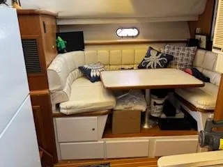 Slide: The Image of Interior of 1995 Carver 440 Aft Cabin Motor Yacht with cozy seating and table. - 19