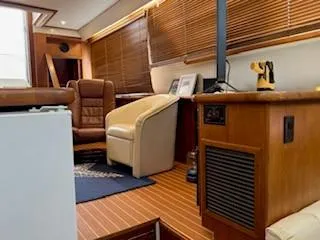 Slide: The Image of Interior of 1995 Carver 440 Aft Cabin Motor Yacht with wood paneling and leather seating. - 20