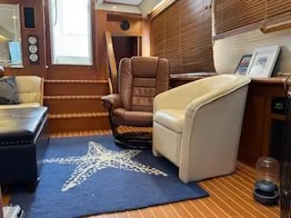 Slide: The Image of Interior of 1995 Carver 440 Aft Cabin Motor Yacht with chairs and starfish rug. - 22