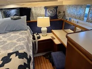 Slide: The Image of Interior of 1995 Carver 440 Aft Cabin Motor Yacht with cozy bedroom setup. - 25