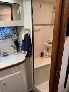 Slide: The Image of Bathroom interior of 1995 Carver 440 Aft Cabin Motor Yacht, featuring sink and shower. - 29