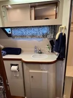 Slide: The Image of 1995 Carver 440 Aft Cabin Motor Yacht bathroom with sink, mirror, and storage. - 31