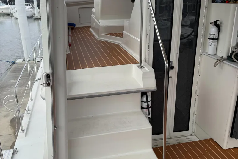 Slide: The Image of 1995 Carver 440 Aft Cabin Motor Yacht interior with stairs and wooden flooring. - 33