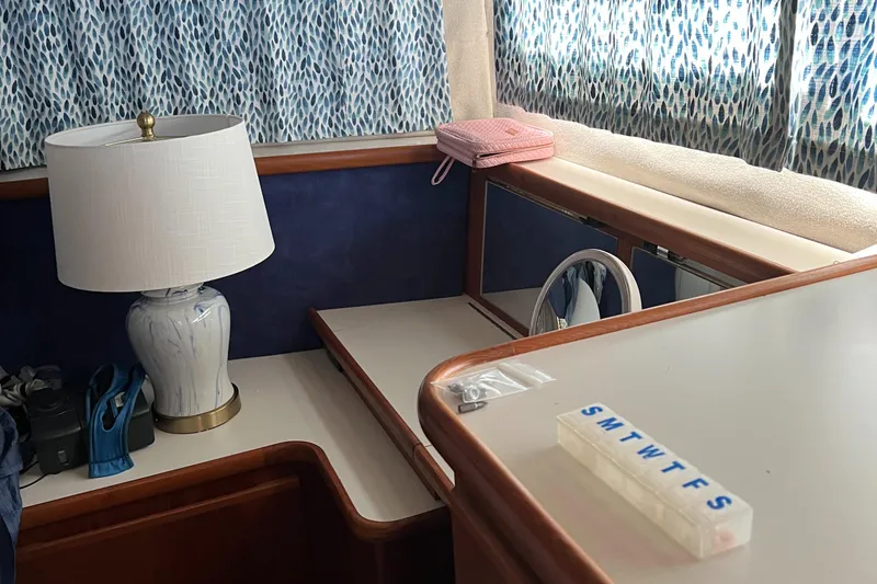 Slide: The Image of 1995 Carver 440 Aft Cabin Motor Yacht interior with lamp, pill organizer, and curtains. - 38