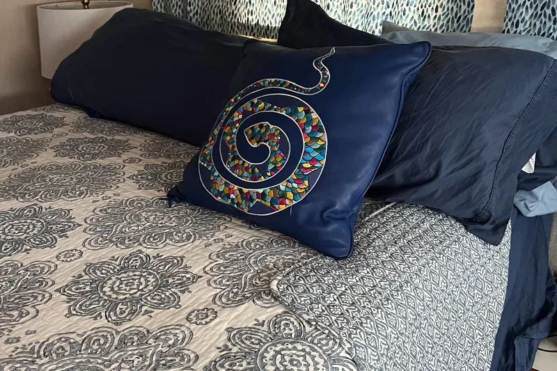 Slide: The Image of Luxurious bedding with patterned quilt and colorful spiral pillow on Carver 440 Aft Cabin Yacht. - 39