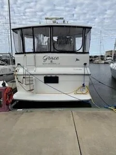 Slide: The Image of 1995 Carver 440 Aft Cabin Motor Yacht docked at marina, rear view. - 5