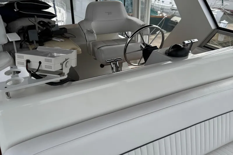 Slide: The Image of 1995 Carver 440 Aft Cabin Motor Yacht helm with steering wheel and controls. - 9