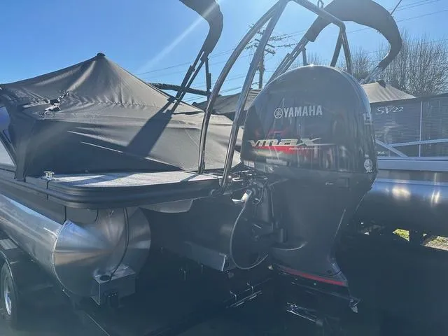 Slide: The Image of 2025 Bennington M Swingback 22 MSB pontoon boat in a warehouse setting. - 2