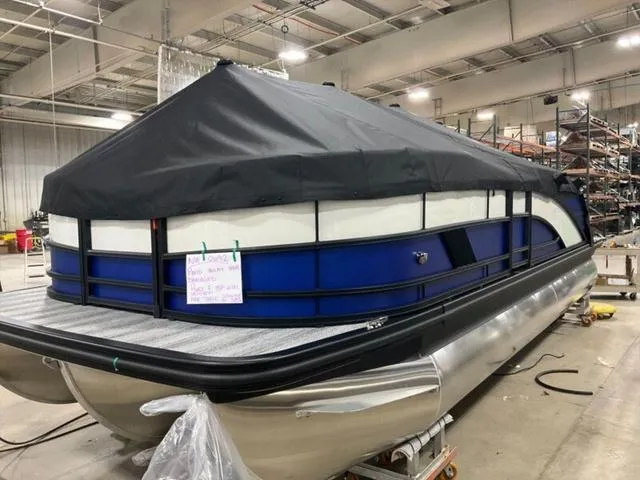 Slide: The Image of 2025 Bennington M Swingback 22 MSB pontoon boat in a warehouse setting. - 5