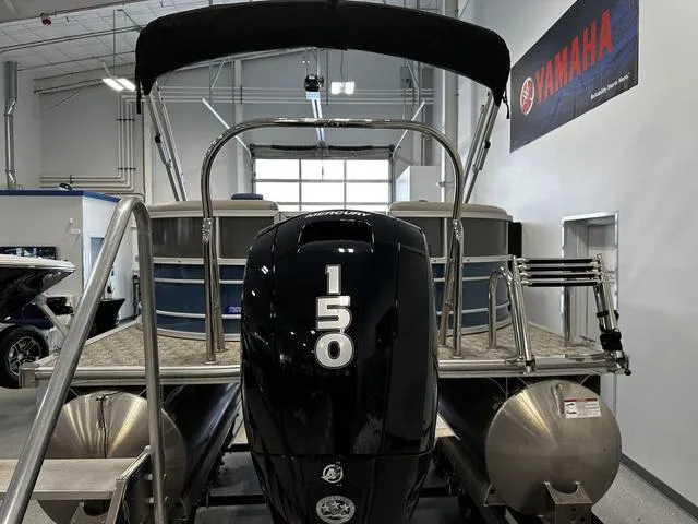 Slide: The Image of 2024 South Bay 222RS LE 2.75 pontoon boat with Mercury 150 engine in showroom. - 3