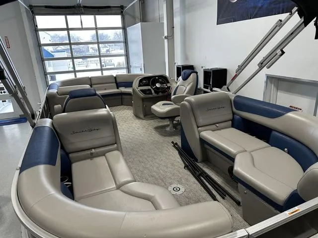 Slide: The Image of 2024 South Bay 222RS LE 2.75 pontoon boat interior with plush seating and modern dashboard. - 4