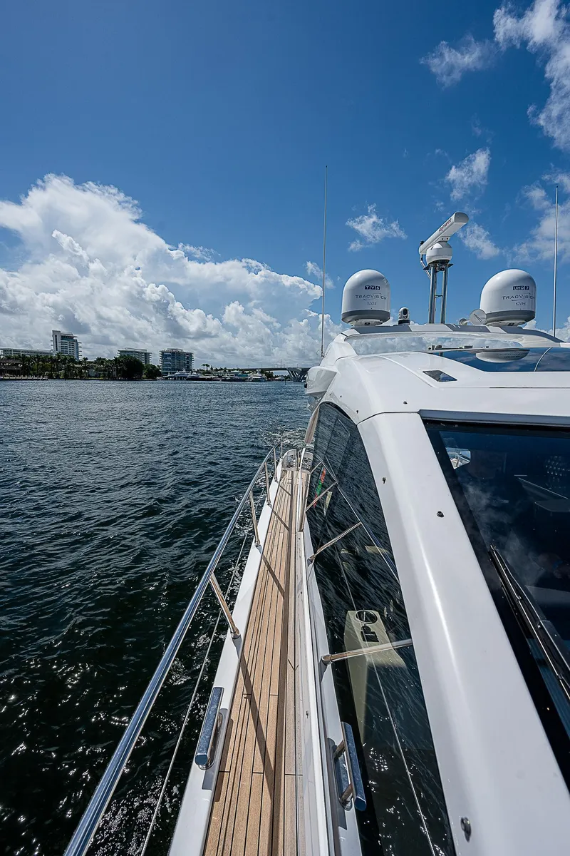 Slide: The Image of 2022 Azimut S6 yacht cruising on a sunny day with clear blue skies. - 19
