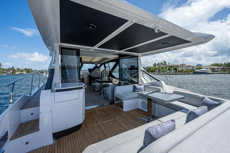 Slide: The Image of 2022 Azimut S6 yacht with luxurious deck and seating, cruising on a sunny day. - 24