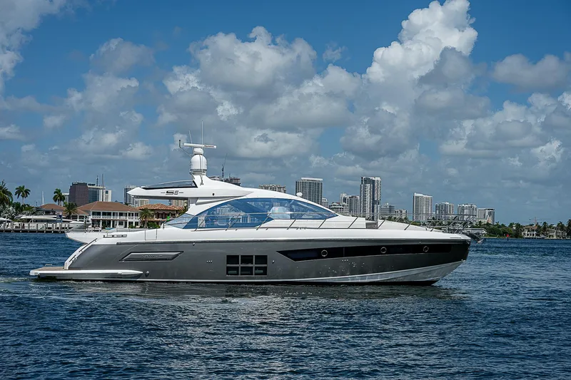 Slide: The Image of 2022 Azimut S6 yacht cruising on a sunny day with city skyline in background. - 4