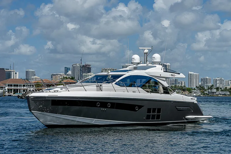 Slide: The Image of 2022 Azimut S6 yacht cruising on a sunny day with city skyline backdrop. - 6