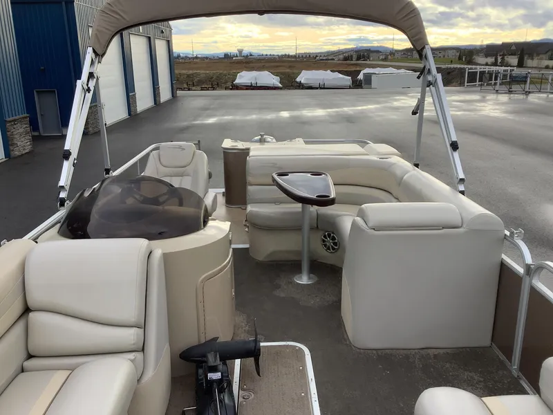 Slide: The Image of 2013 Bennington 2275 pontoon boat interior with beige seating and canopy. - 10