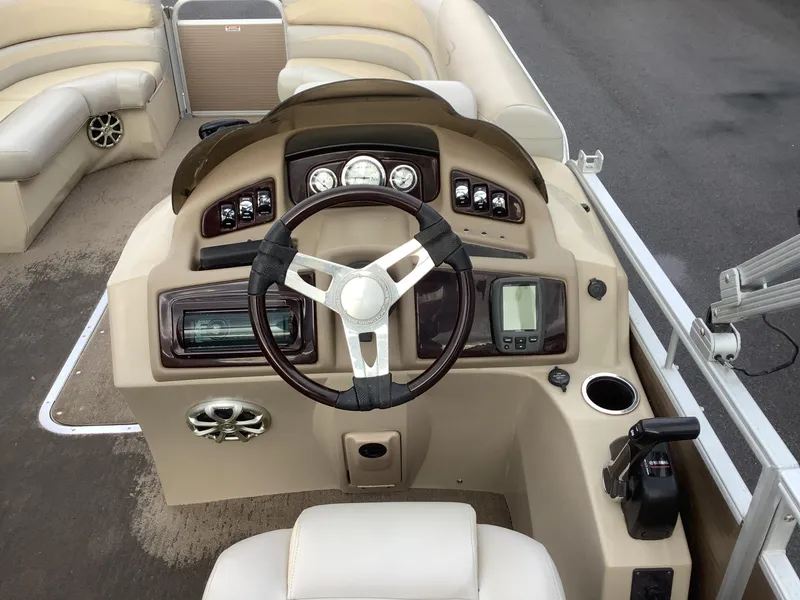 Slide: The Image of 2013 Bennington 2275 boat dashboard with steering wheel and control panel. - 14