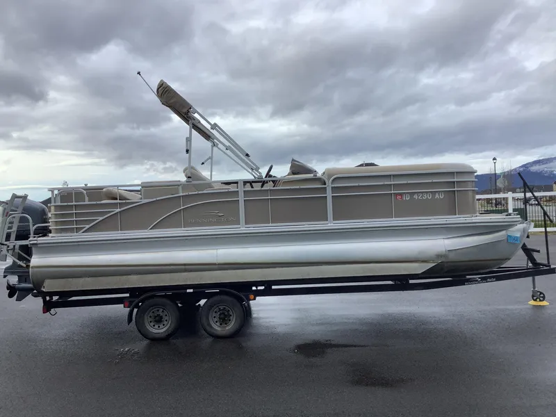 Slide: The Image of 2013 Bennington 2275 pontoon boat on trailer under cloudy sky. - 5