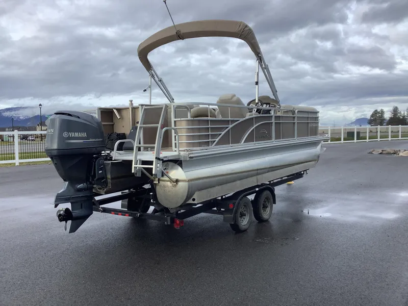 Slide: The Image of 2013 Bennington 2275 pontoon boat with Yamaha motor on trailer, cloudy sky background. - 6