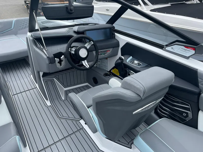 Slide: The Image of 2024 Nautique Super Air G25 boat interior with modern dashboard and seating. - 12