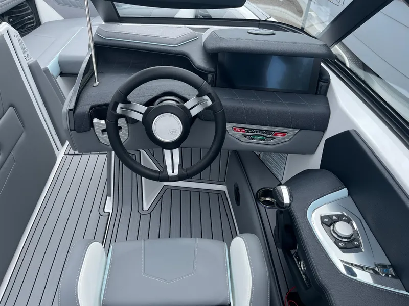 Slide: The Image of 2024 Nautique Super Air G25 cockpit with modern steering wheel and control panel. - 13