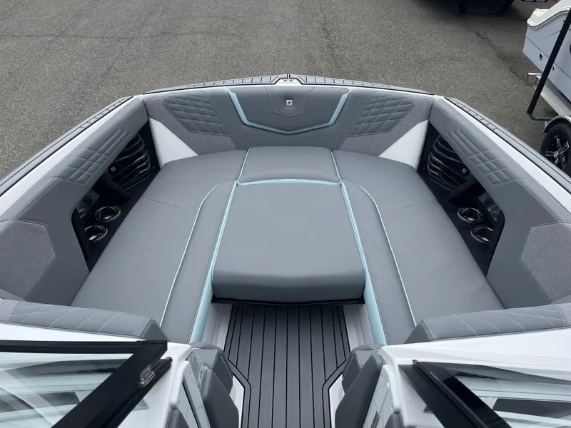 Slide: The Image of 2024 Nautique Super Air G25 boat interior with luxurious gray seating and cup holders. - 15