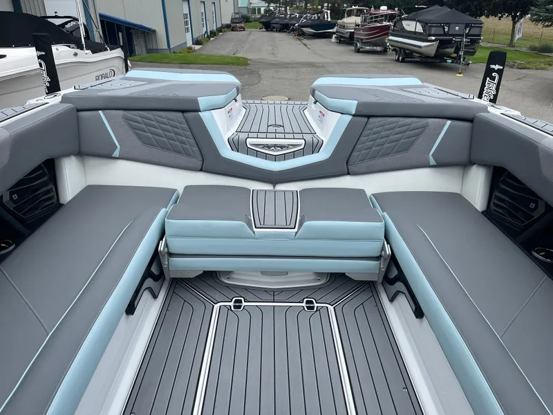 Slide: The Image of 2024 Nautique Super Air G25 boat interior with gray and blue seating. - 16