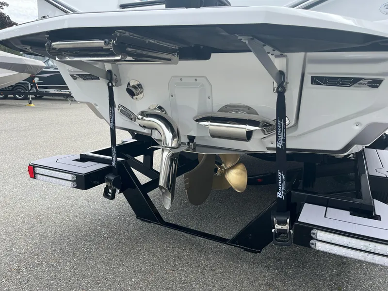 Slide: The Image of 2024 Nautique Super Air G25 boat stern with propeller and exhaust system. - 19