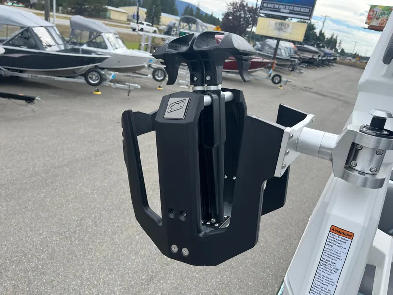 Slide: The Image of 2024 Nautique Super Air G25 boat accessory, docked with other boats in the background. - 21