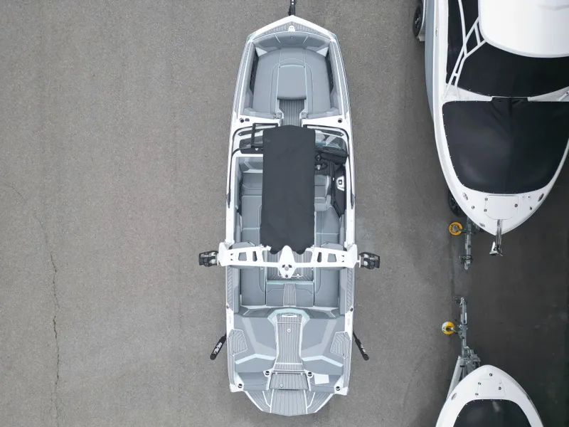 Slide: The Image of 2024 Nautique Super Air G25 boat, aerial view, parked on pavement. - 6
