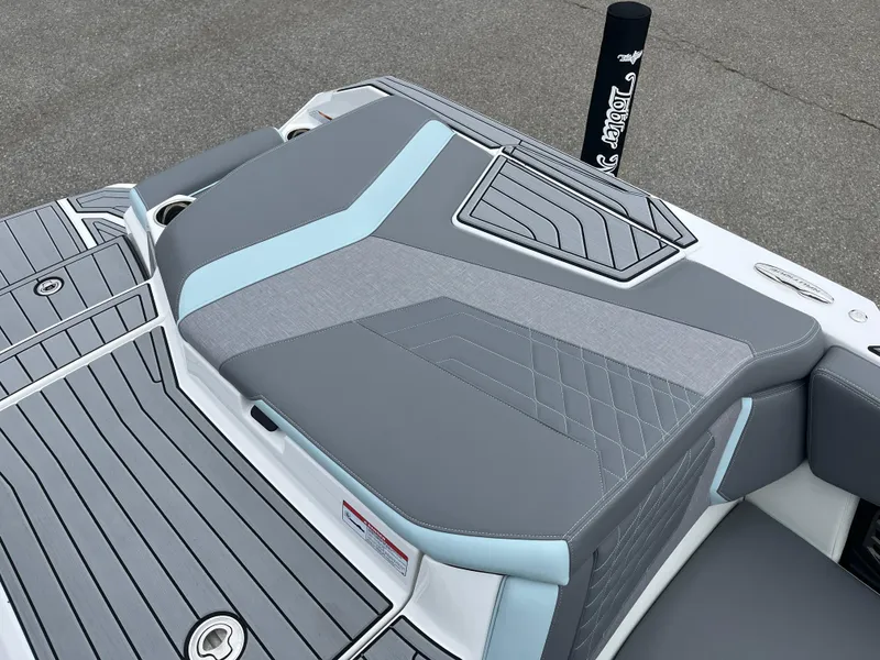 Slide: The Image of 2024 Nautique Super Air G25 boat with sleek gray and blue seating design. - 9