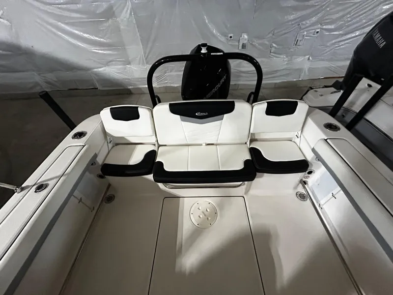 Slide: The Image of 2023 Robalo 207 boat interior with white and black seating, showcasing modern design. - 6