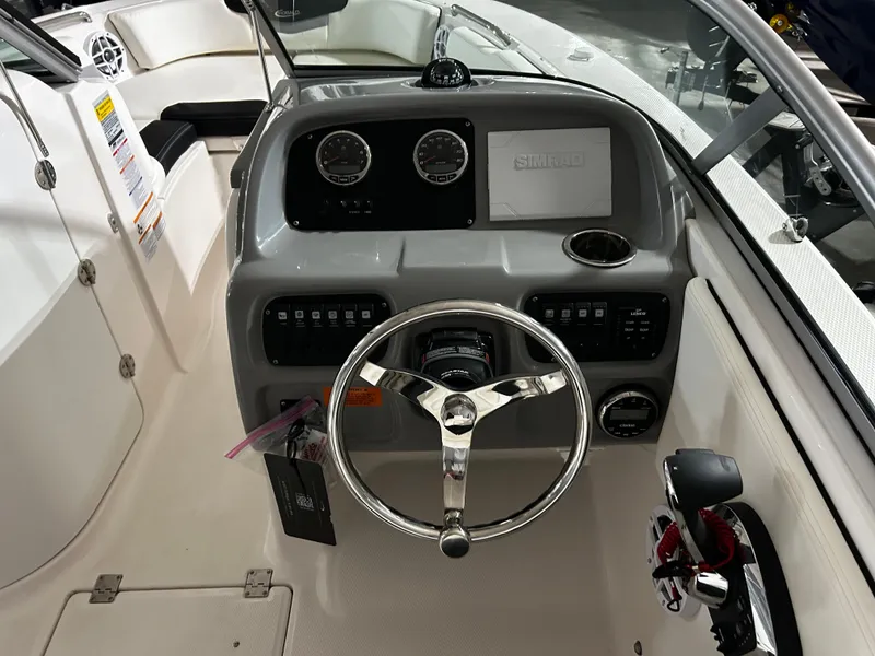 Slide: The Image of 2023 Robalo 207 boat dashboard with steering wheel and control panel. - 7