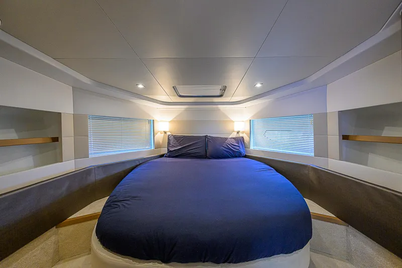 Slide: The Image of Luxurious bedroom interior of 2017 Beneteau Gran Turismo 49 yacht with blue bedding. - 13