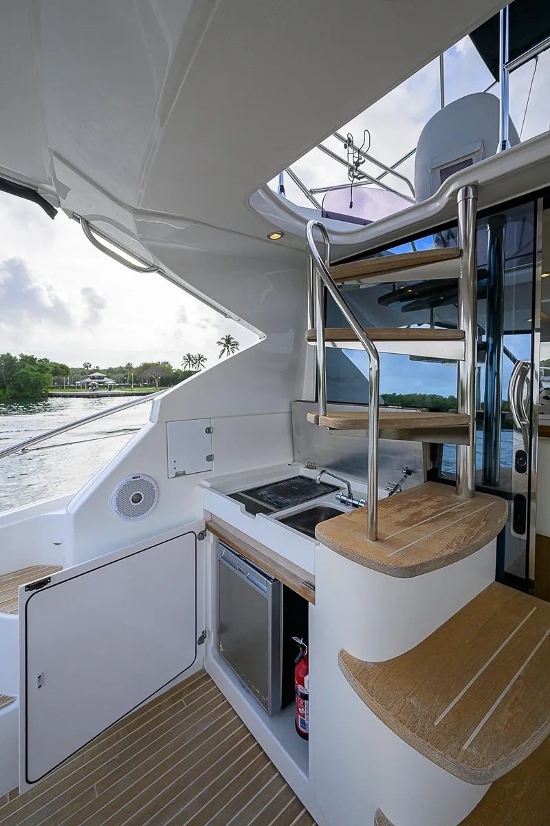 Slide: The Image of 2017 Beneteau Gran Turismo 49 yacht interior with modern kitchenette and spiral staircase. - 15