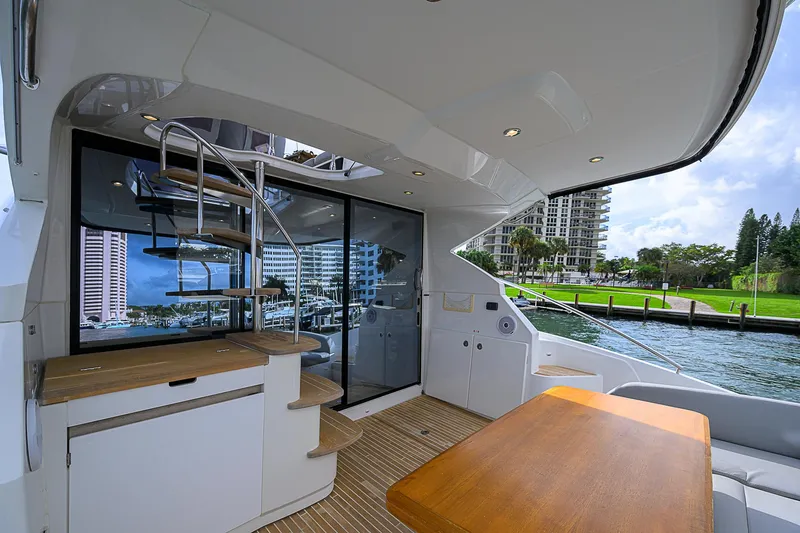 Slide: The Image of 2017 Beneteau Gran Turismo 49 yacht interior with spiral staircase and waterfront view. - 4
