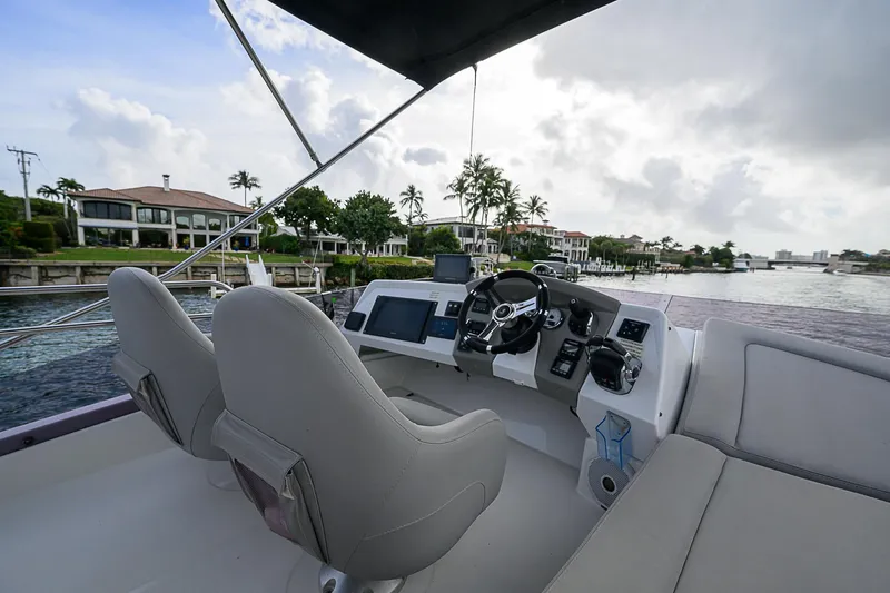 Slide: The Image of 2017 Beneteau Gran Turismo 49 yacht helm with waterfront view. - 49