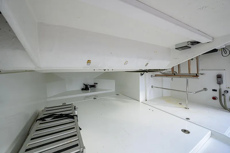 Slide: The Image of 2017 Beneteau Gran Turismo 49 interior, showcasing spacious white storage area with ladder. - 58