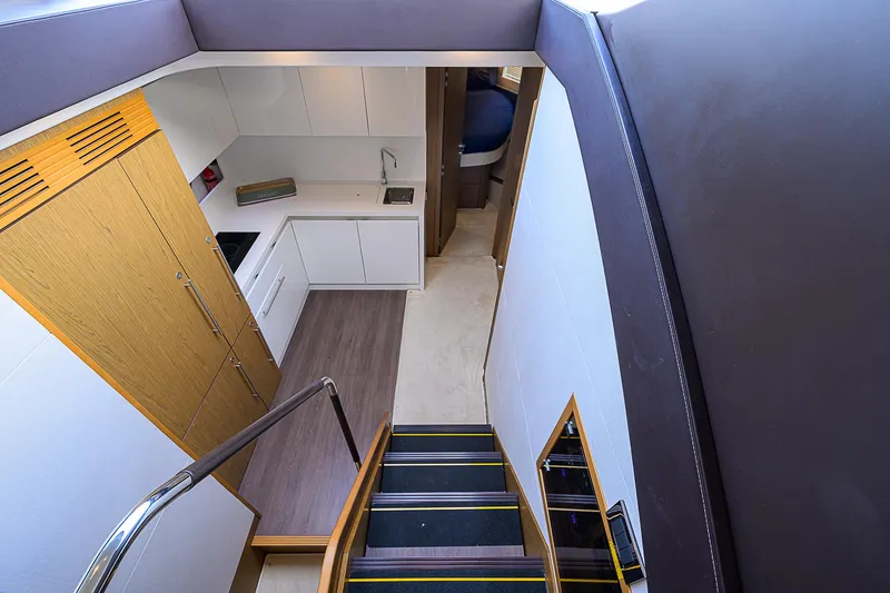 Slide: The Image of Interior view of 2017 Beneteau Gran Turismo 49 yacht, featuring modern kitchen and stairs. - 60