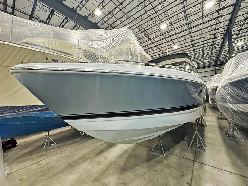 Slide: The Image of 2013 Formula 290 Bowrider boat in storage, covered and elevated on stands. - 31