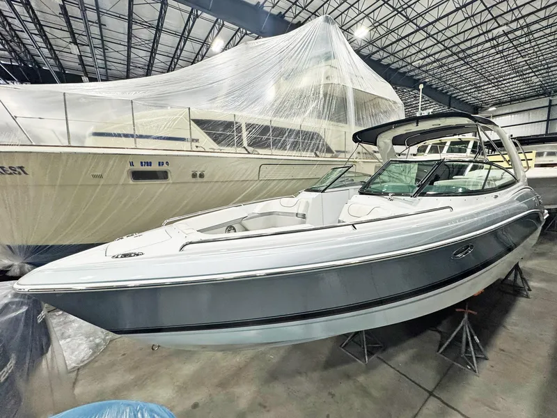 Slide: The Image of 2013 Formula 290 Bowrider boat in indoor storage, sleek design, elevated on stands. - 32