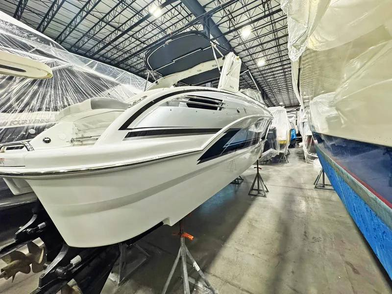 Slide: The Image of 2013 Formula 290 Bowrider in storage, sleek design, elevated on stands. - 33
