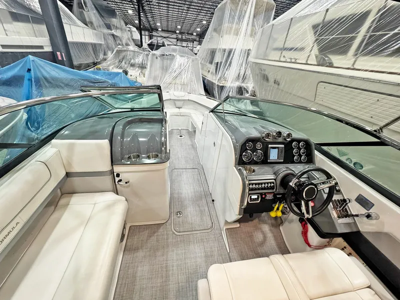 Slide: The Image of 2013 Formula 290 Bowrider interior with modern dashboard and seating in a covered storage area. - 43